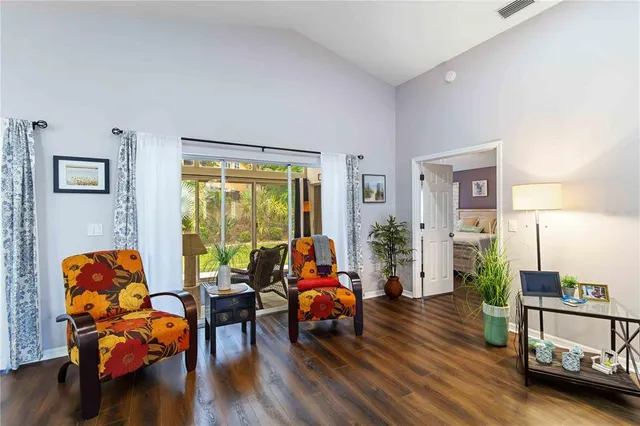 a kitchen with stainless steel appliances a refrigerator and a wooden floor