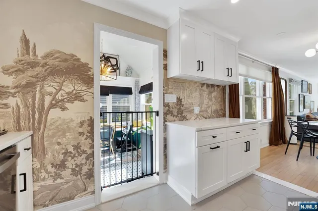 a dining room with furniture a chandelier and wooden floor