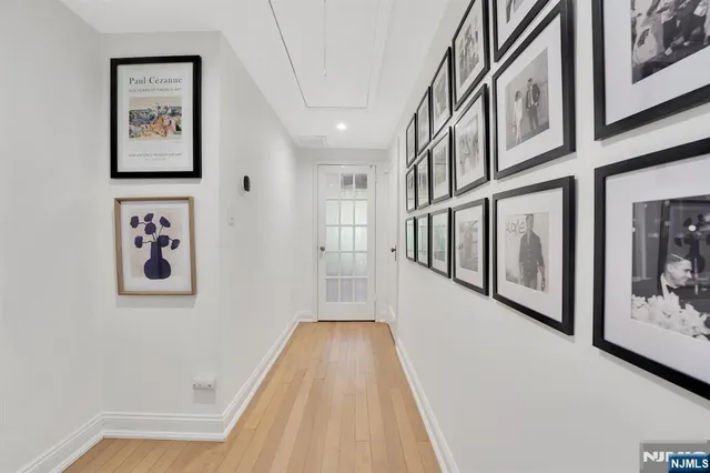 a bedroom with a bed table chair and a window