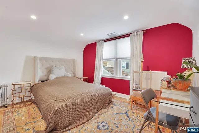 a bathroom with a bathtub sink and mirror