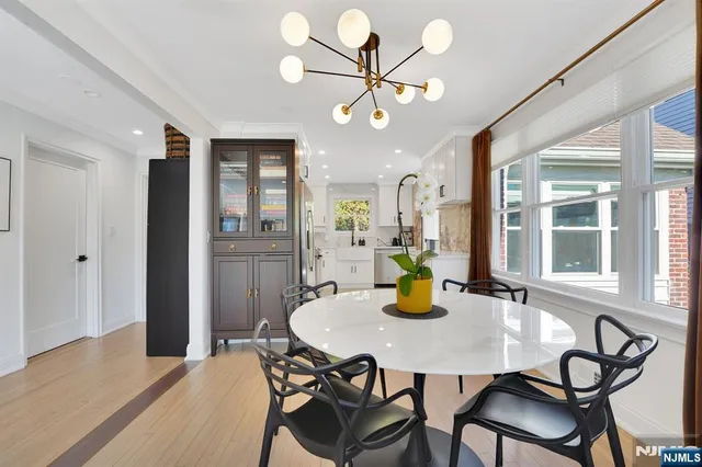 a view of a dining room with a table and chairs
