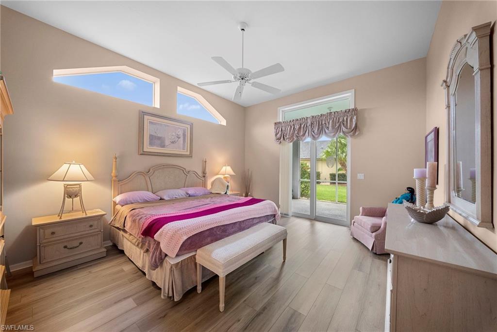 3971 Spring Garden Lane Estero, FL 33928 - Photo 9 of 31 a bedroom with a bed and a chandelier