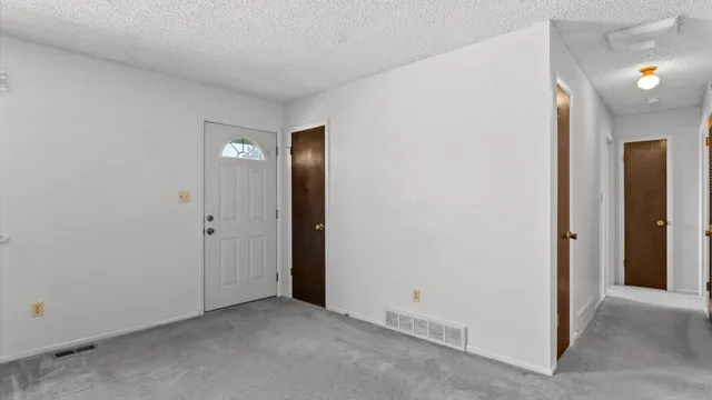 a view of an empty room and closet area