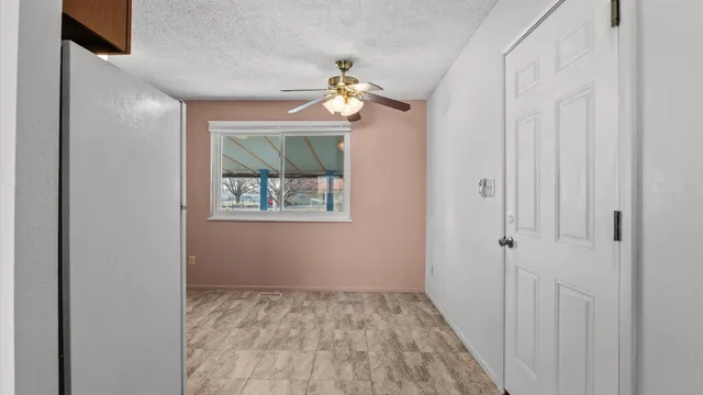 a view of a hallway with a chandelier fan