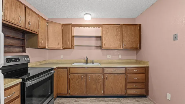 a kitchen with a sink stove and cabinets
