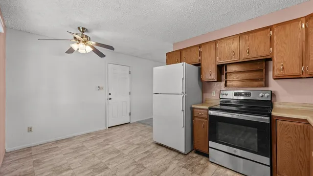 a kitchen with cabinets and stainless steel appliances