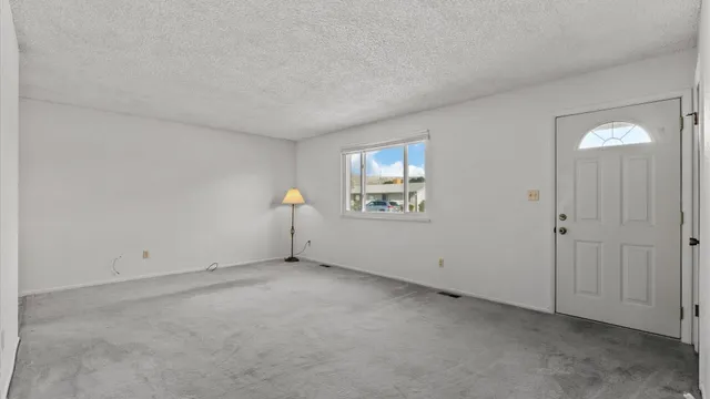 a view of an empty room with a window