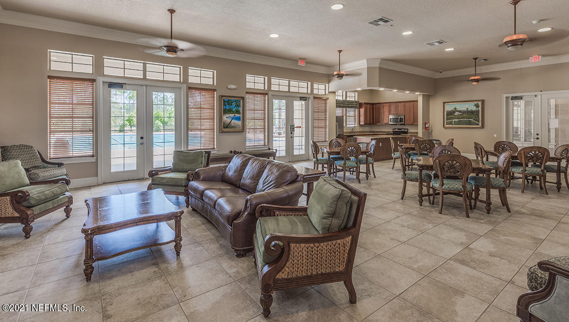 65461 Crested Heron Yulee, FL 32097 - Photo 4 of 14 a living room with furniture and a large window