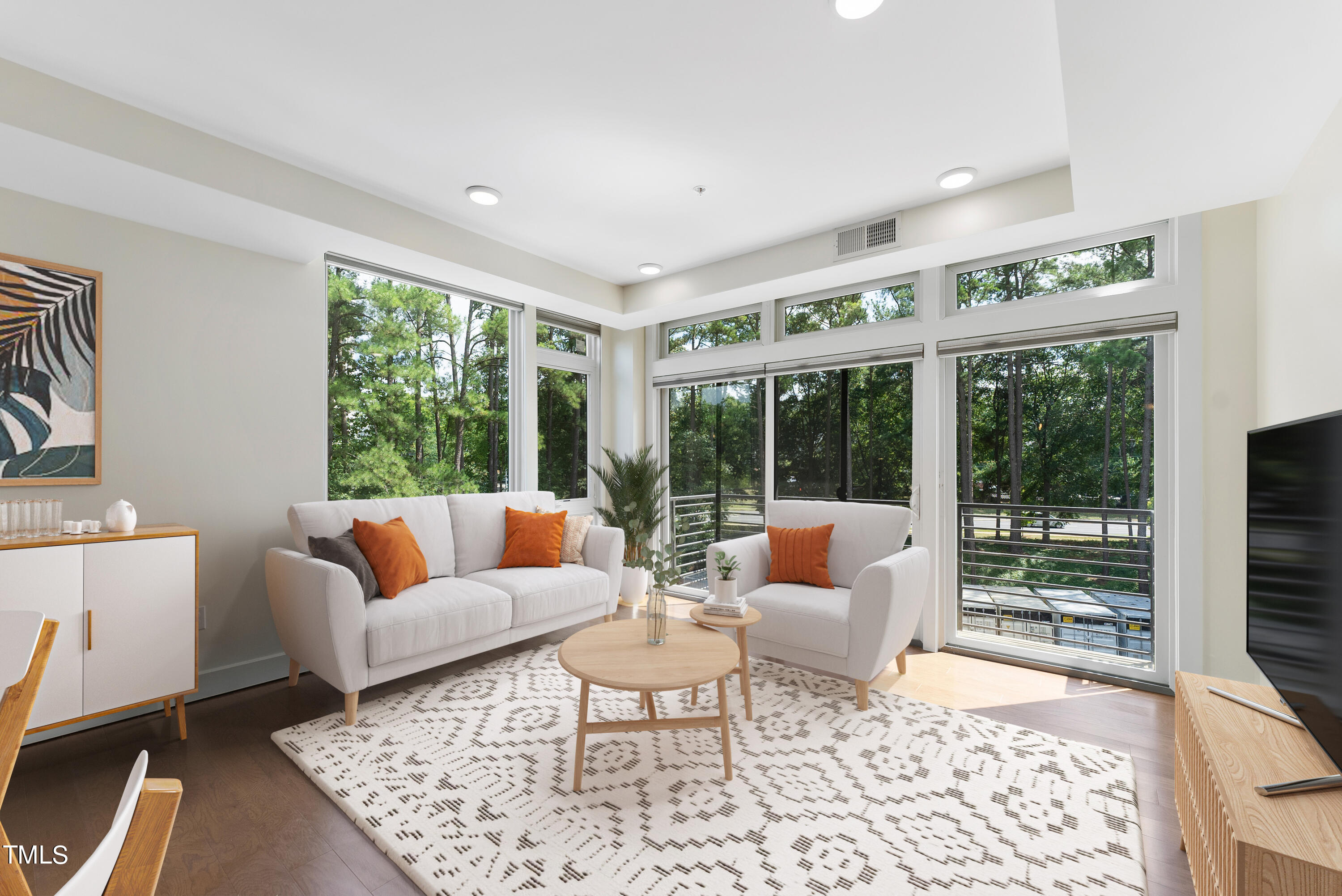 1300 St Marys Street, Unit 301 Raleigh, NC 27605 - Photo 1 of 27 a living room with furniture and large windows