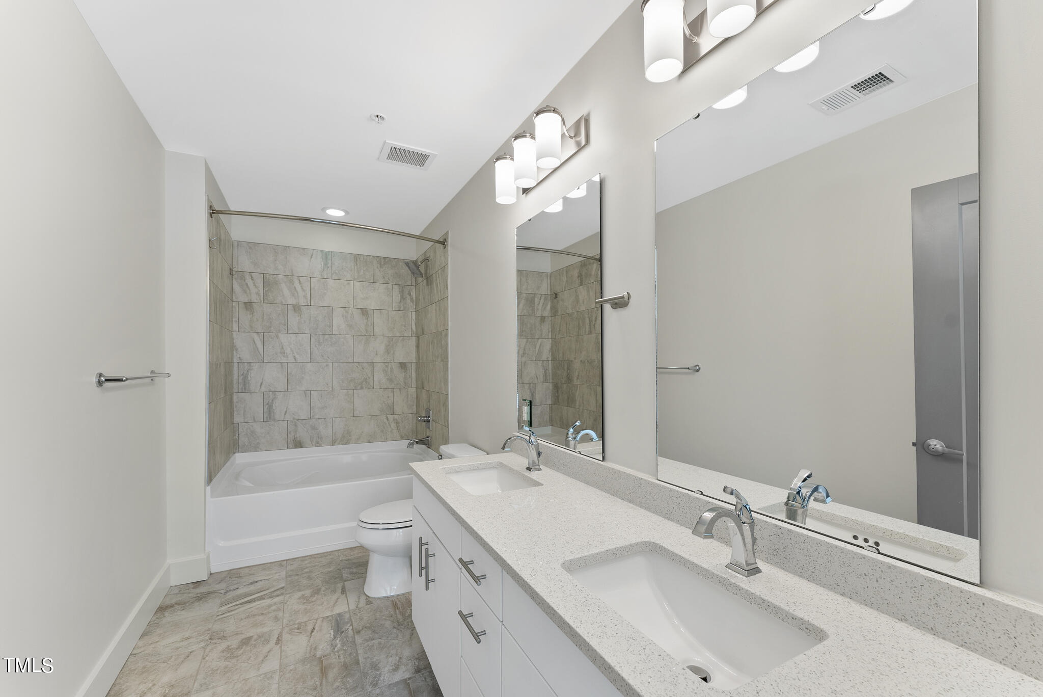 1300 St Marys Street, Unit 301 Raleigh, NC 27605 - Photo 12 of 27 a bathroom with a tub double sink shower and mirror