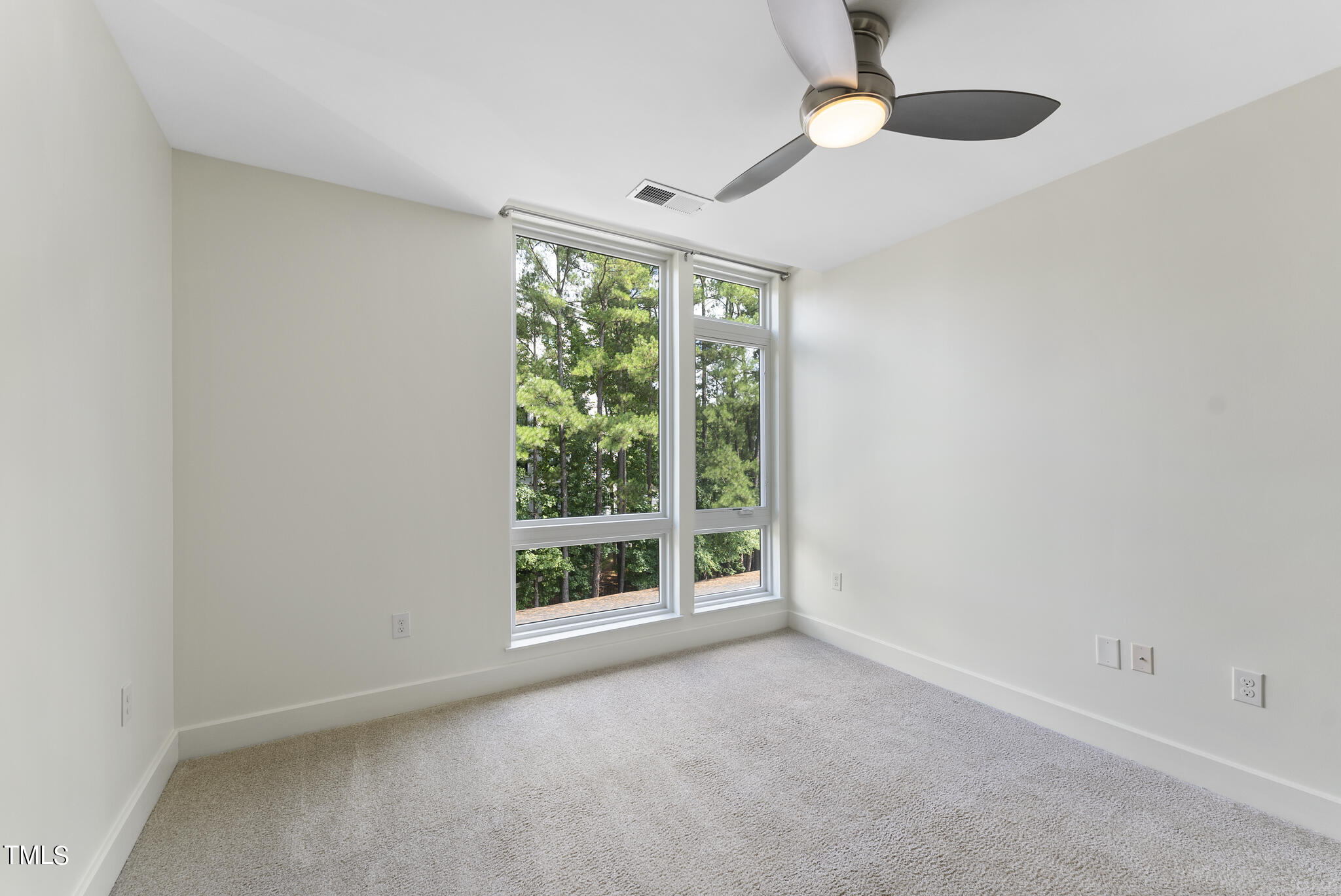 1300 St Marys Street, Unit 301 Raleigh, NC 27605 - Photo 13 of 27 an empty room with windows