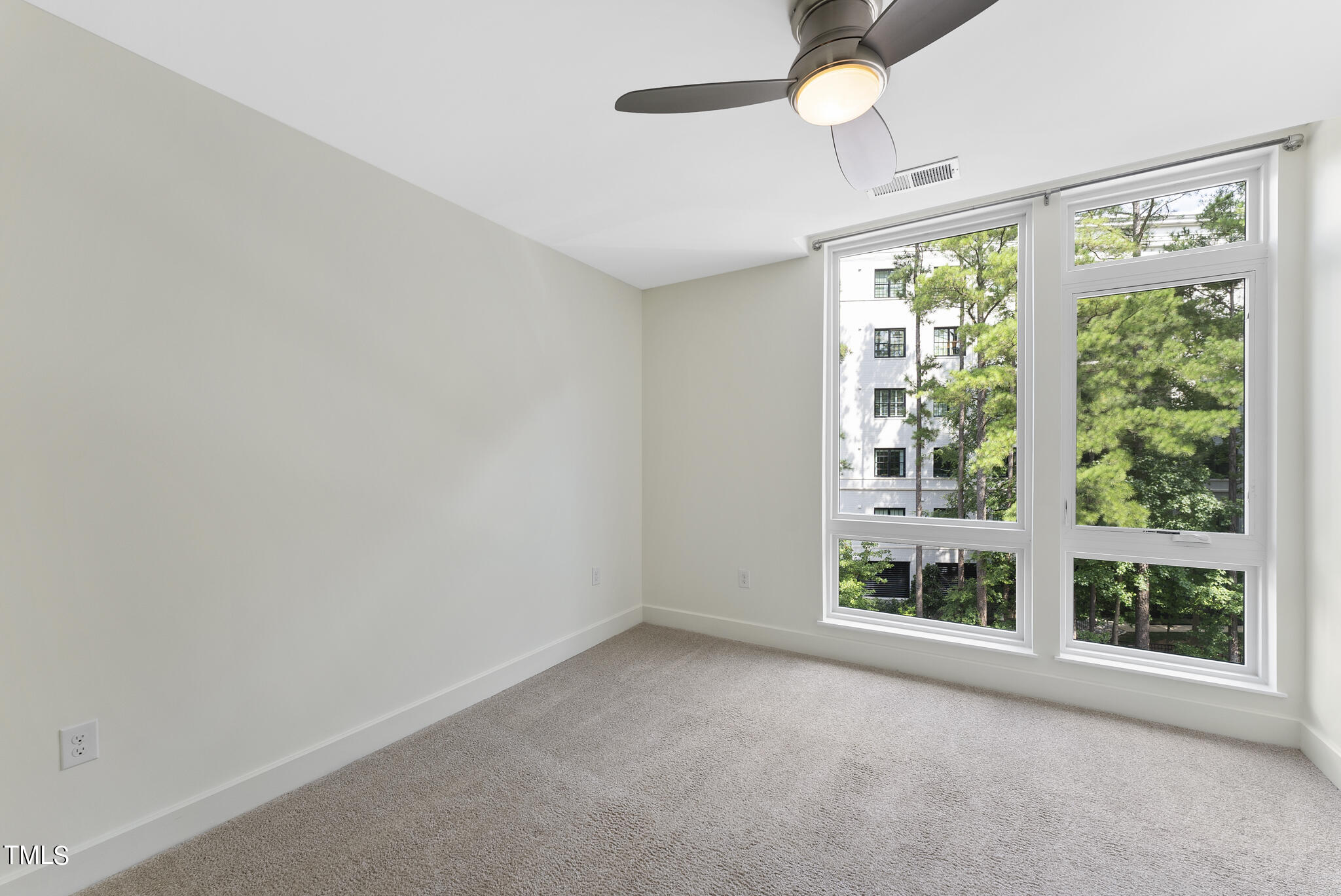 1300 St Marys Street, Unit 301 Raleigh, NC 27605 - Photo 14 of 27 a view of an empty room with a window