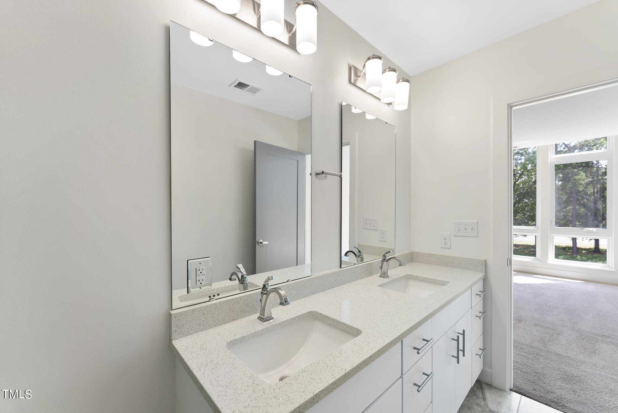 1300 St Marys Street, Unit 301 Raleigh, NC 27605 - Photo 15 of 27 a bathroom with a sink double vanity and a mirror