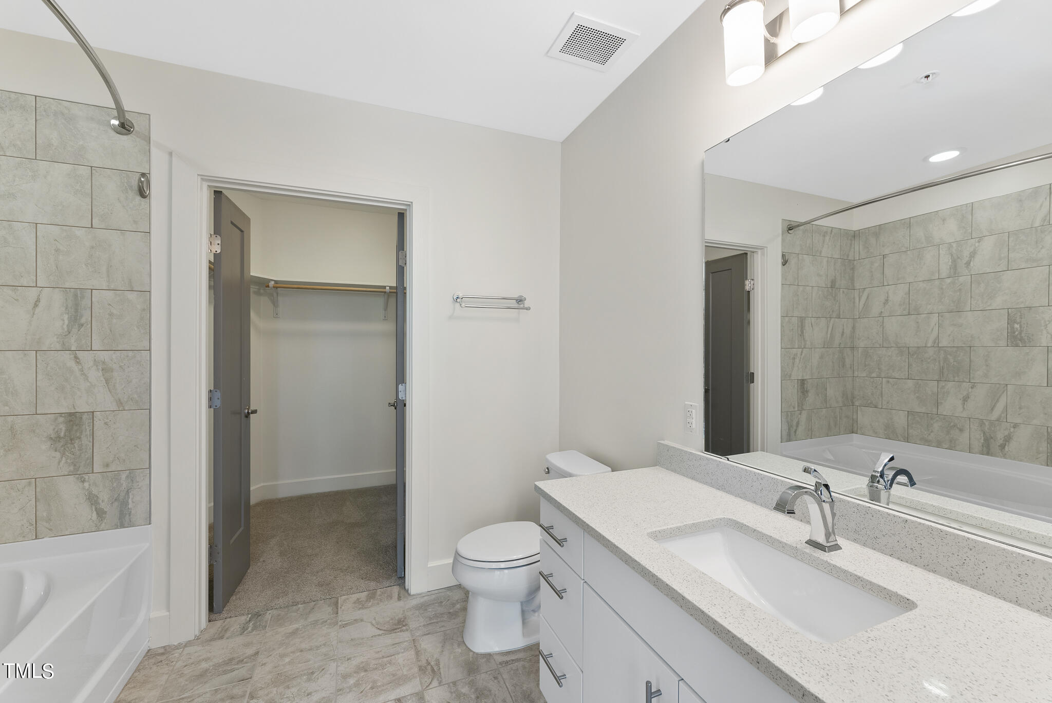 1300 St Marys Street, Unit 301 Raleigh, NC 27605 - Photo 16 of 27 a bathroom with a granite countertop sink a toilet and shower