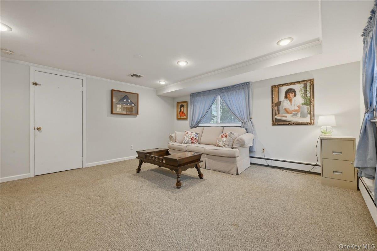 17 Avon Road Farmingdale, NY 11735 - Photo 26 of 46 a living room with furniture and a night stand