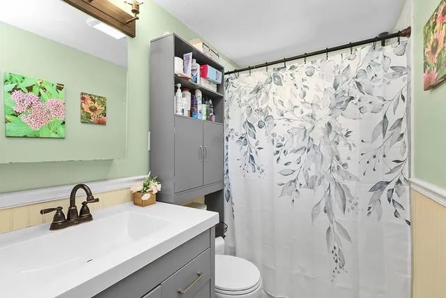 a bathroom with a sink toilet and shower