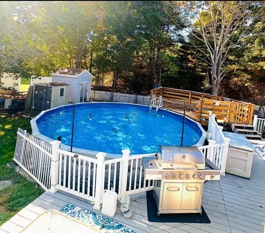 a view of a roof deck with couches chairs and wooden floor