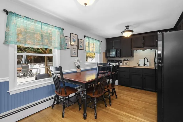 a view of a dining room with furniture window and wooden floor