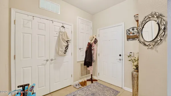 a view of a dining room with furniture a livingroom and chandelier