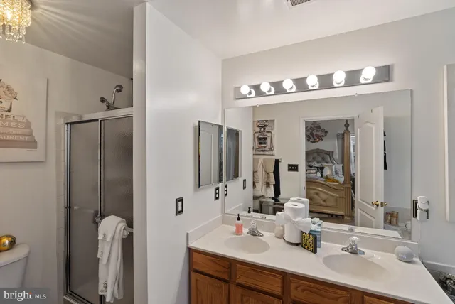a view of a hallway with entryway chandelier fan and windows
