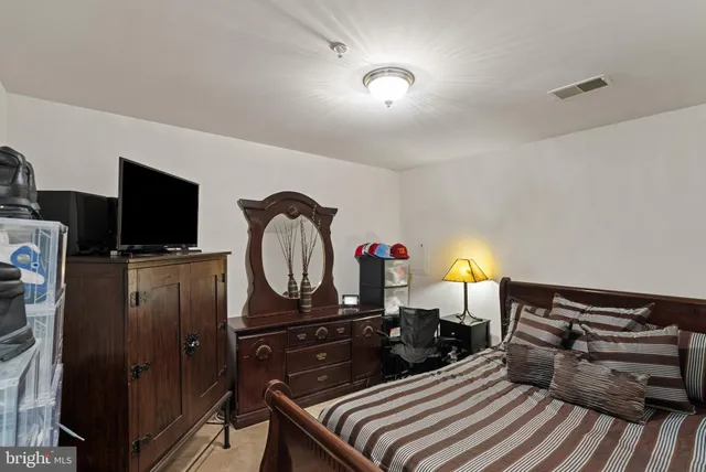 a view of a patio with table and chairs under an umbrella