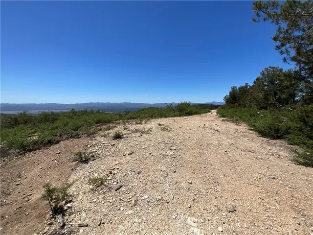 a view of ocean beach and mountain