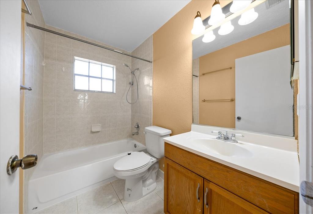 14906 Southwest 38th Circle Ocala, FL 34473 - Photo 12 of 24 a bathroom with a sink a toilet and shower