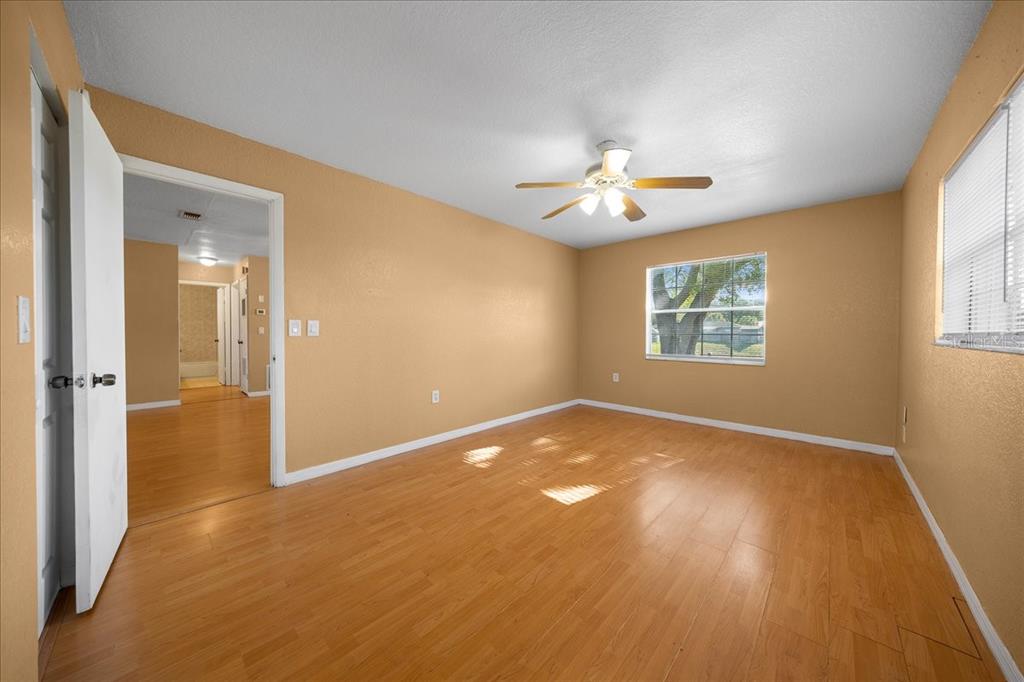 14906 Southwest 38th Circle Ocala, FL 34473 - Photo 15 of 24 wooden floor in an empty room with a window