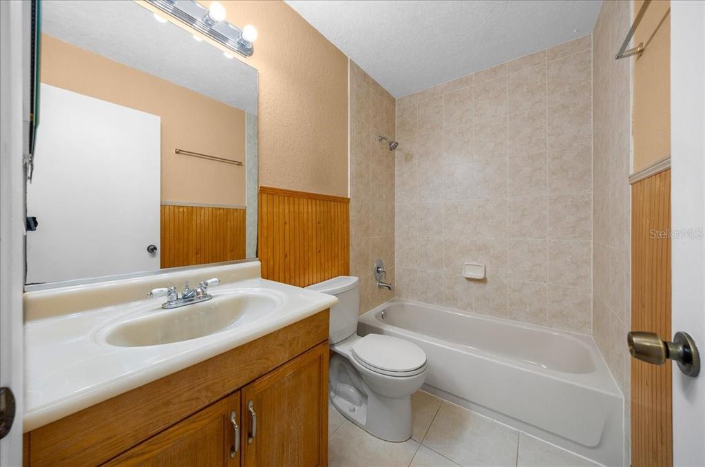 14906 Southwest 38th Circle Ocala, FL 34473 - Photo 16 of 24 a bathroom with a granite countertop sink a toilet and shower