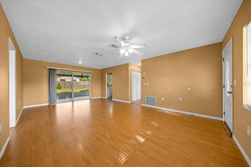 14906 Southwest 38th Circle Ocala, FL 34473 - Photo 5 of 24 a view of an empty room with window and wooden floor