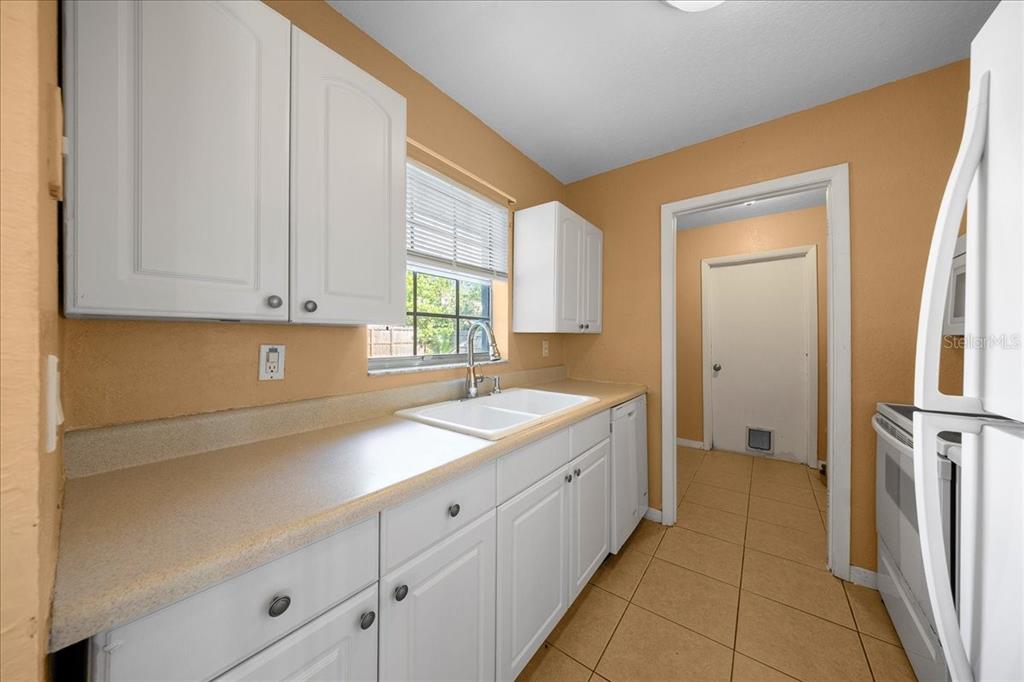 14906 Southwest 38th Circle Ocala, FL 34473 - Photo 7 of 24 a kitchen with a sink and cabinets