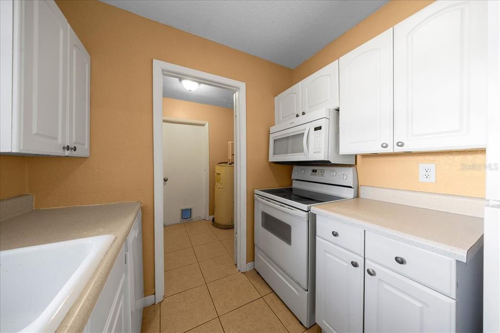 14906 Southwest 38th Circle Ocala, FL 34473 - Photo 8 of 24 a kitchen with granite countertop white cabinets and white appliances