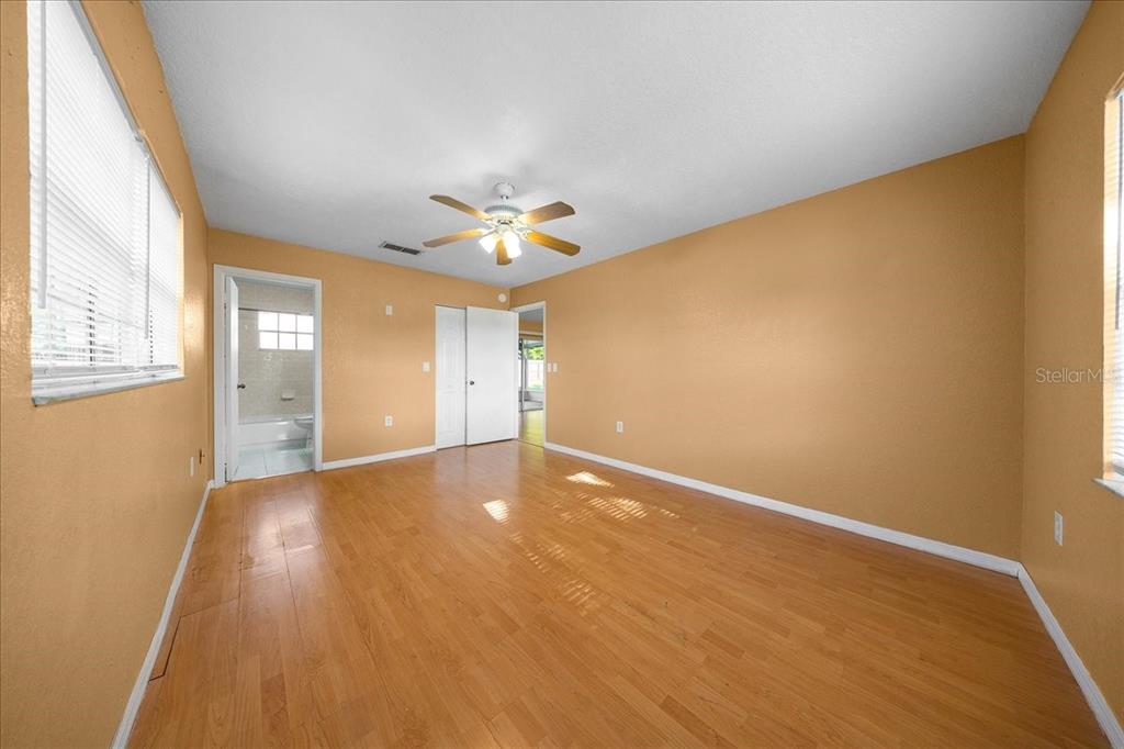 14906 Southwest 38th Circle Ocala, FL 34473 - Photo 10 of 24 an empty room with wooden floor and windows