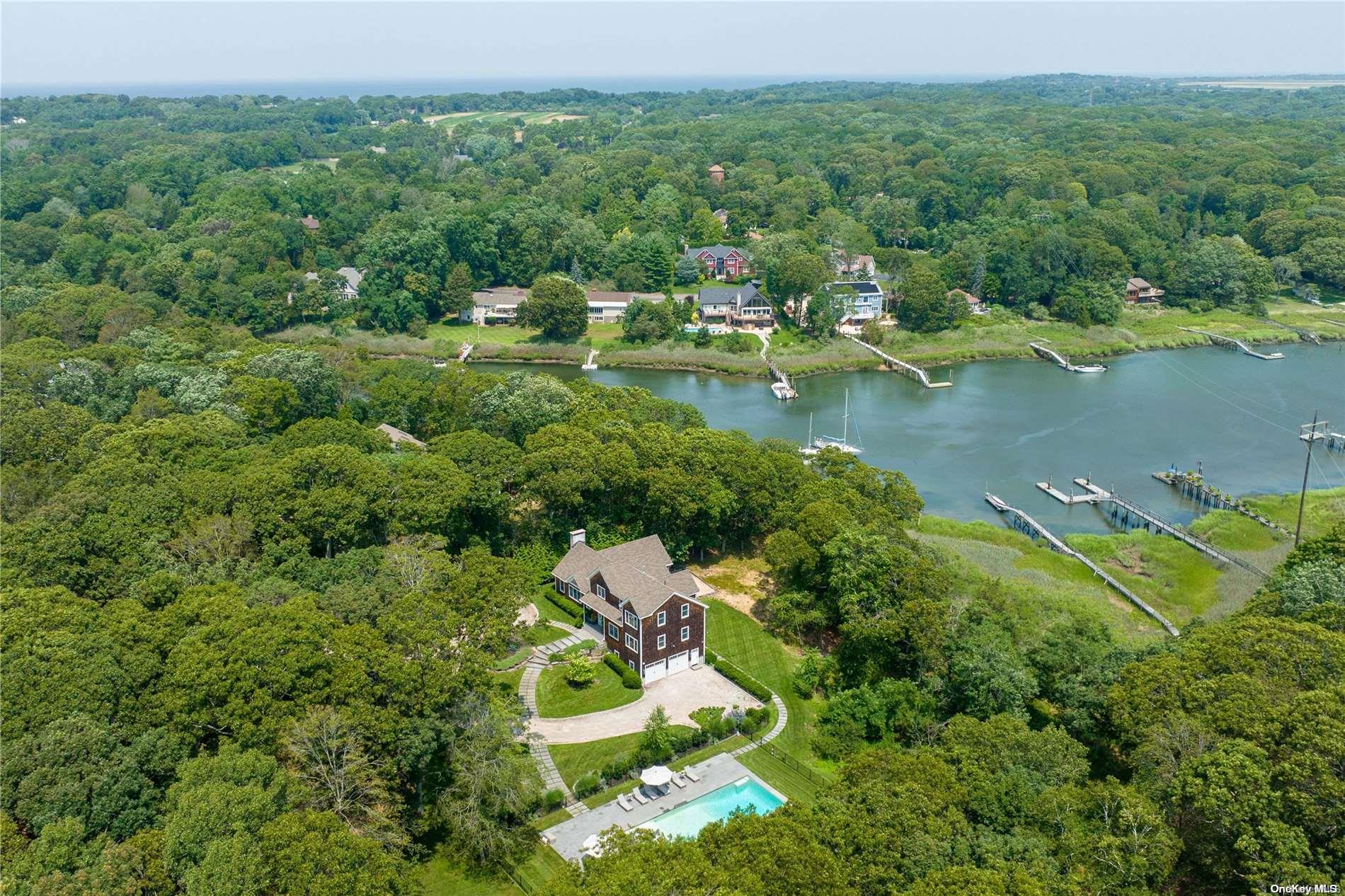 an aerial view of a house with a yard and lake view