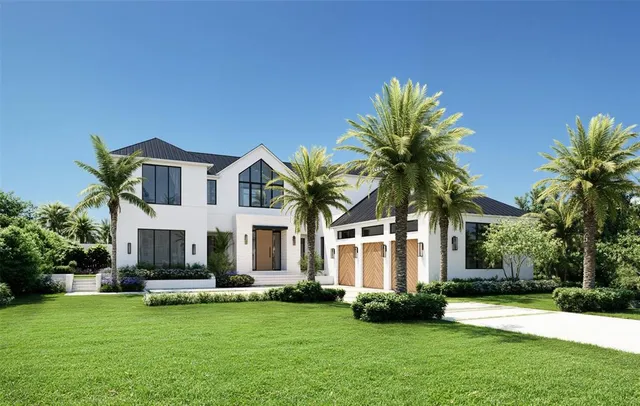 a front view of a house with a garden and plants