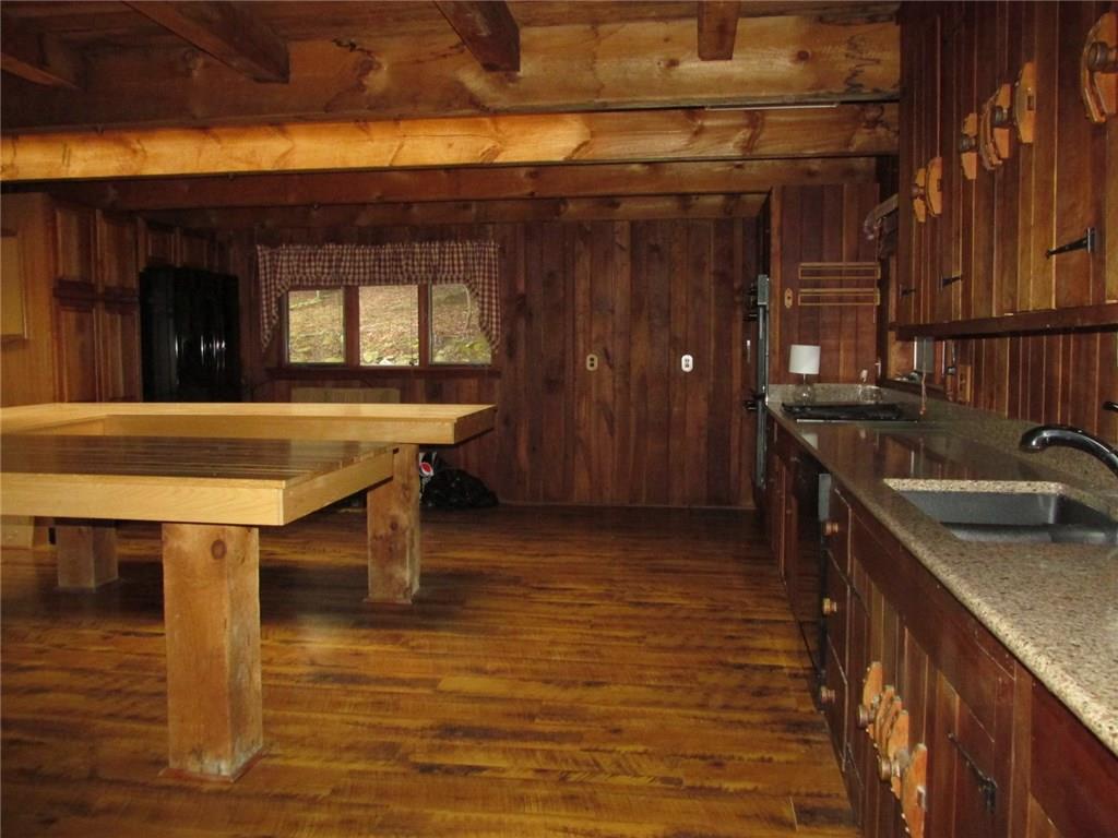 188 County Line Road Champion, PA 15622 - Photo 2 of 25 At 22x22 this kitchen was made for entertaining! Above the U shaped kitchen island are two skylights that allow the sun to shine inside! Take note of the original hardware on the cupboards.