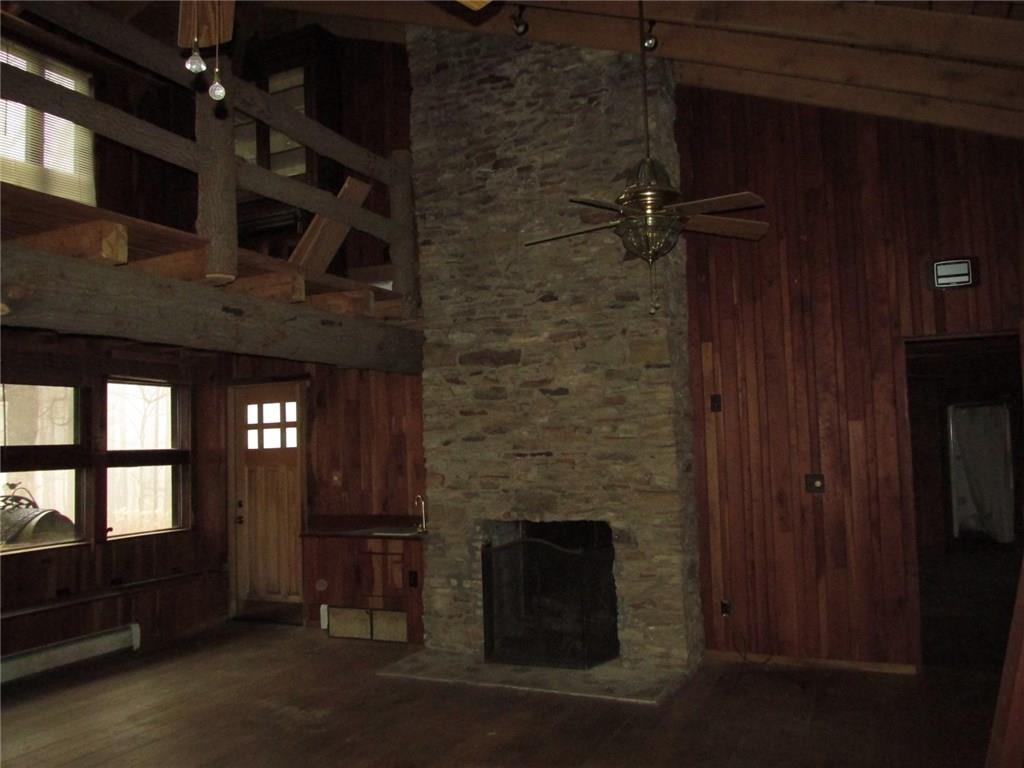 188 County Line Road Champion, PA 15622 - Photo 21 of 25 This is the fifth fireplace, how about the gorgeous floor to ceiling stone work! The door on the left leads to the outside patio. On the right is the entrance to the third bedroom/family room. You may be wondering if this bedroom is trapped but there is another private entrance!