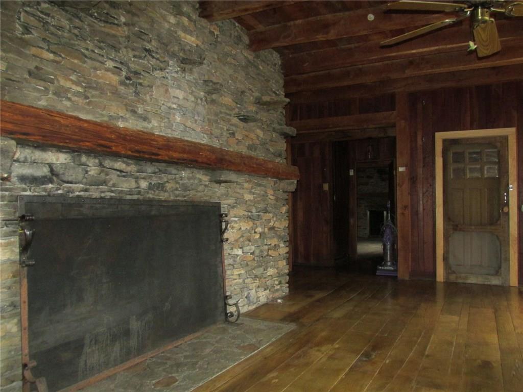 188 County Line Road Champion, PA 15622 - Photo 6 of 25 A closer look at the stone work on the fireplace. See how some stones were extended for shelves? Back the hallway is another bedroom.