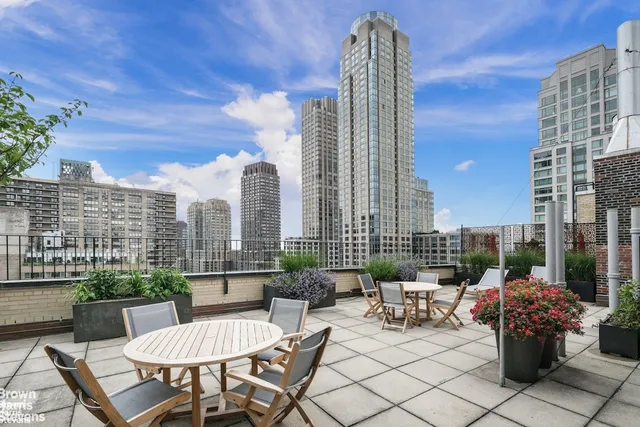 a view of a terrace with furniture and a view