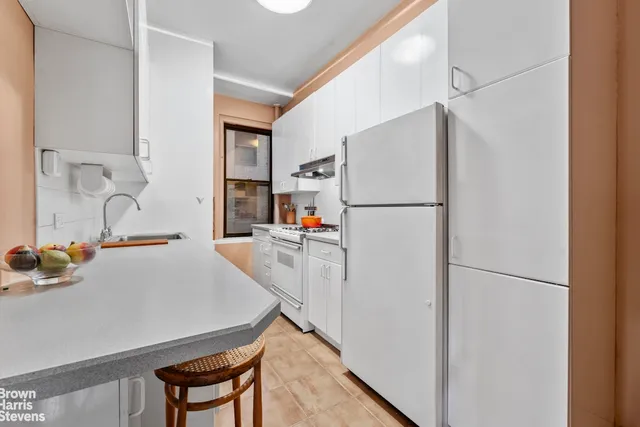 a white refrigerator freezer sitting in a kitchen