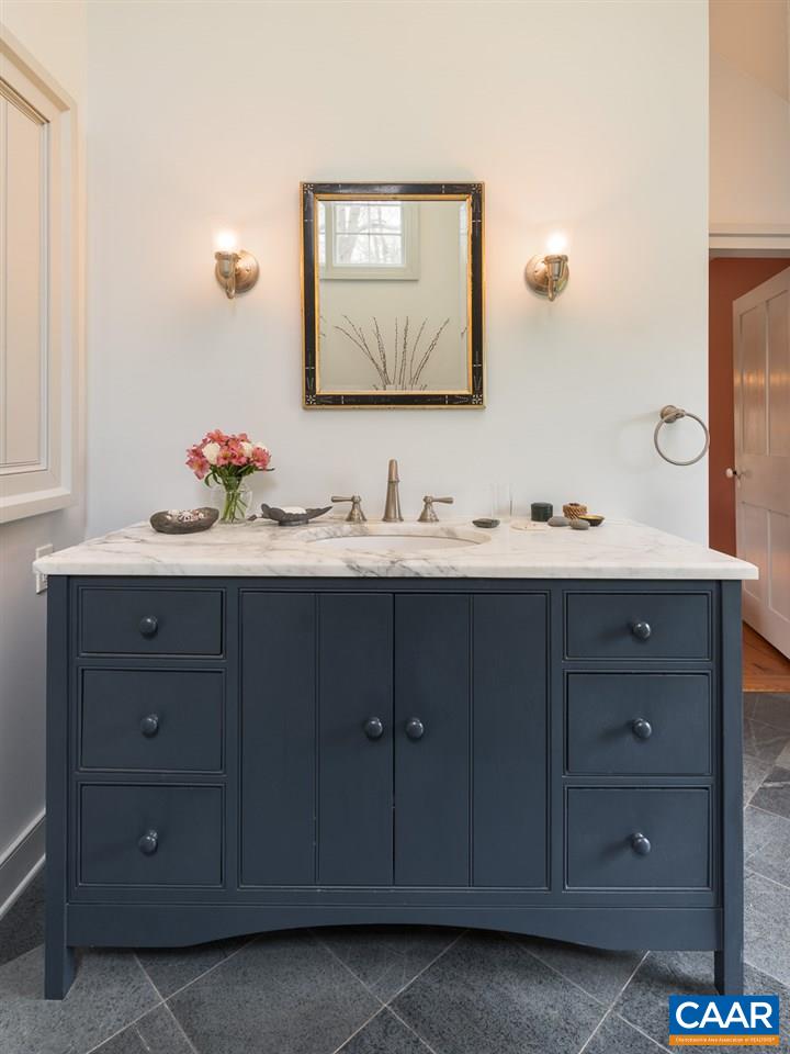 7124 Plank Road Charlottesville, VA 22903 - Photo 13 of 16 a bathroom with a double vanity sink and a mirror