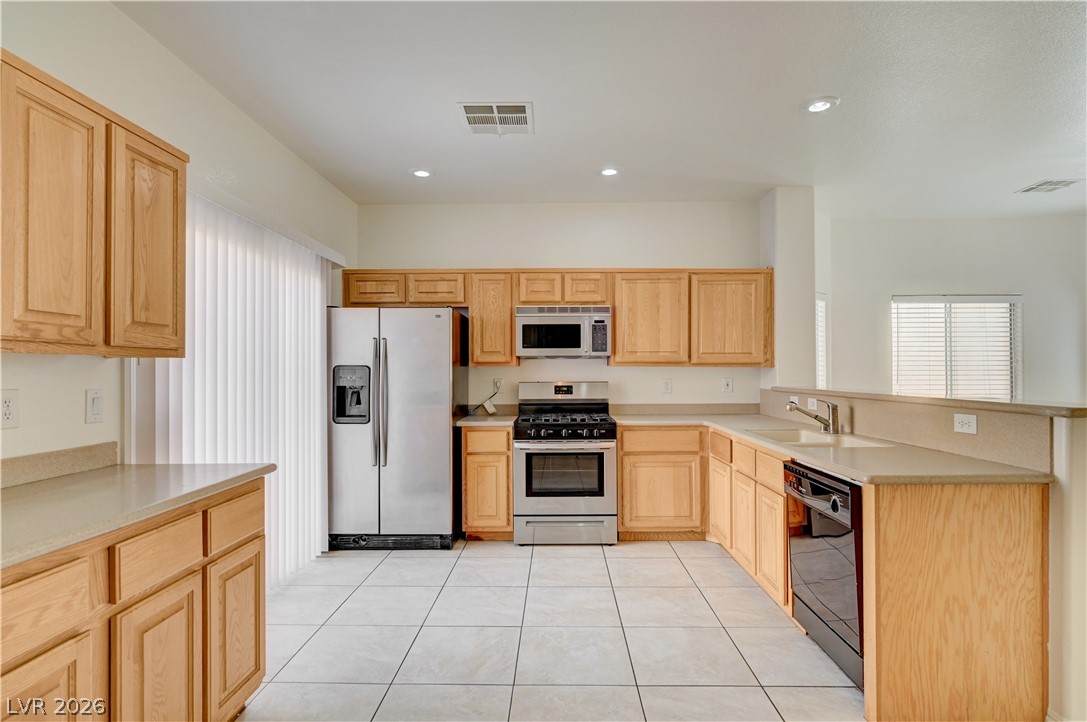 8918 Houston Ridge Avenue Las Vegas, NV 89178 - Photo 5 of 35 A well-appointed kitchen features ample cabinetry, recessed lighting, and modern stainless steel appliances.