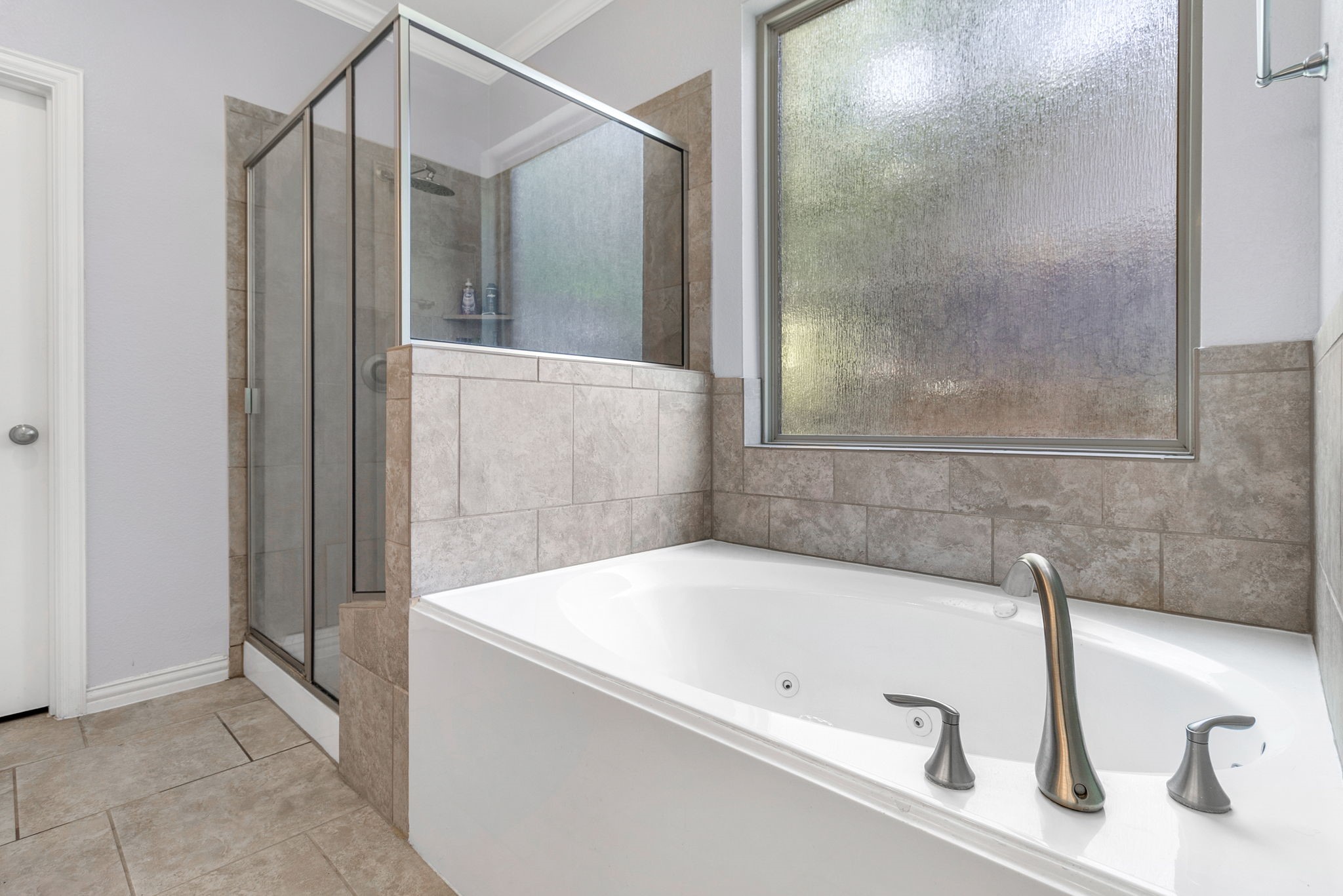 9014 San Saba Way Willis, TX 77378 - Photo 11 of 18 a bathroom with a tub and a shower