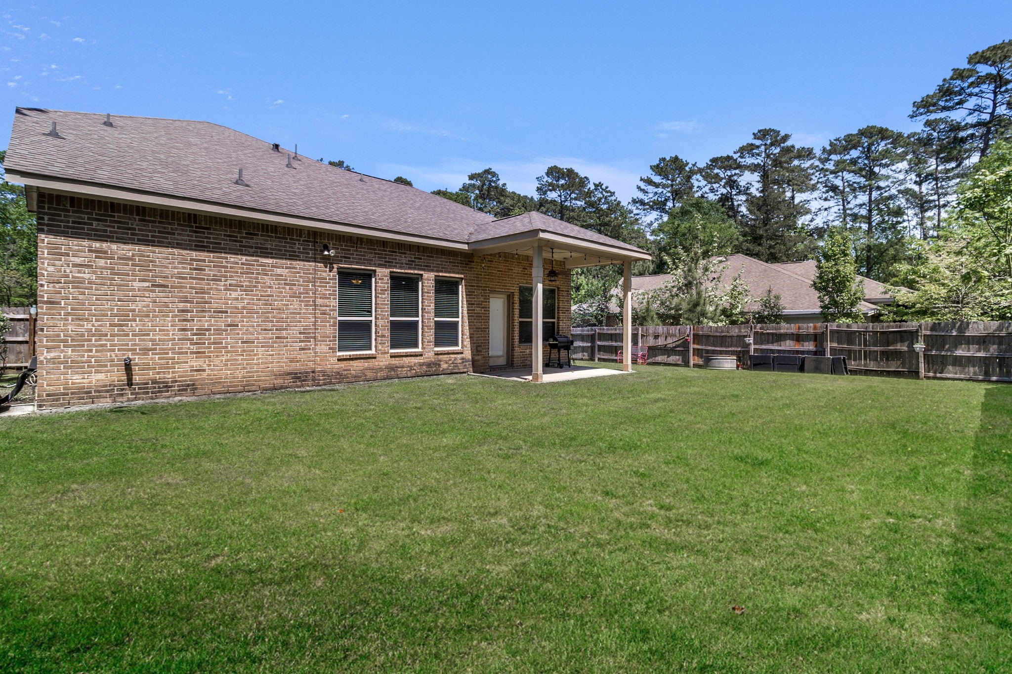 9014 San Saba Way Willis, TX 77378 - Photo 18 of 18 a view of a house with a backyard