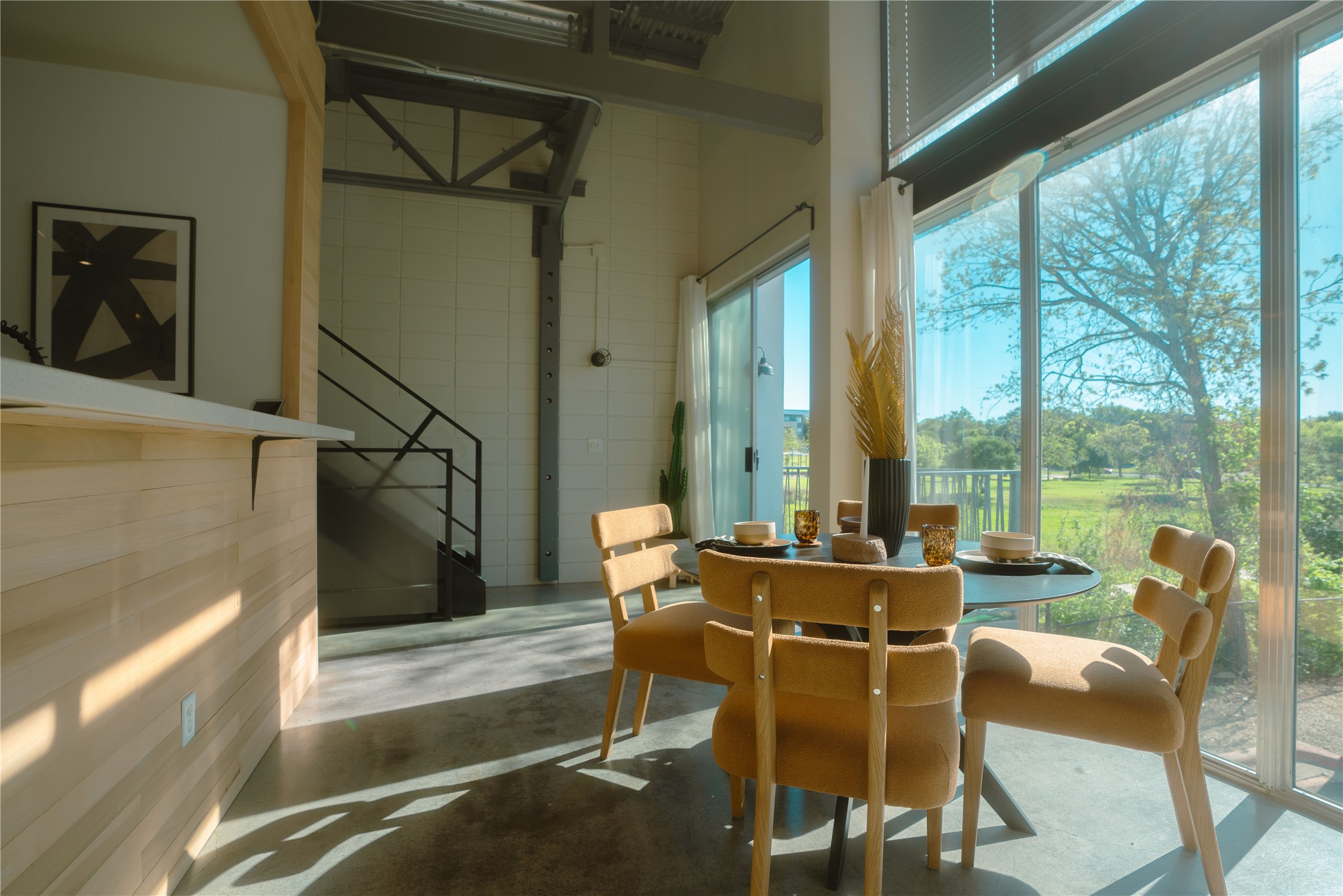 4801 South Congress Avenue, Unit H5 Austin, TX 78745 - Photo 4 of 39 Dining area featuring finished concrete flooring and a high ceiling