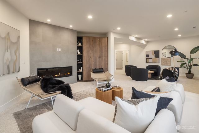 a living room with furniture and a view of kitchen