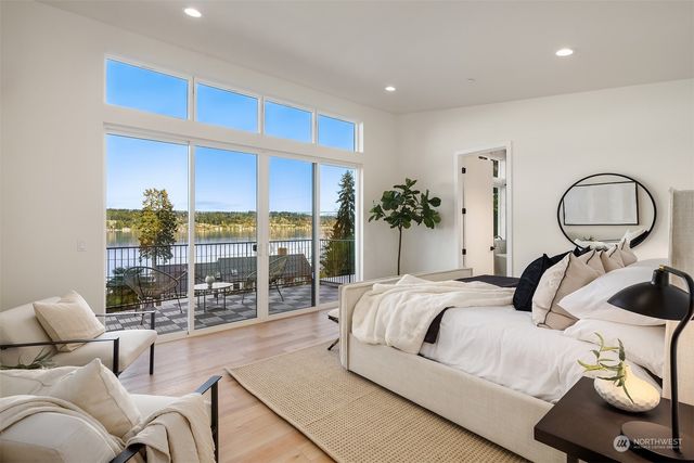 a bedroom with a large bed and ceiling fan