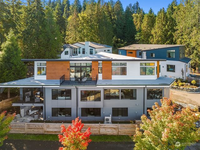 a front view of a house with swimming pool and glass windows