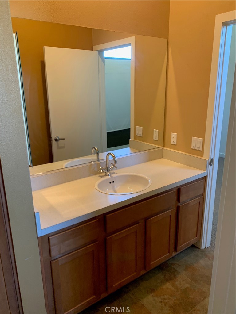 60055 Overture Drive Palm Springs, CA 92262 - Photo 11 of 19 a bathroom with a sink and a mirror