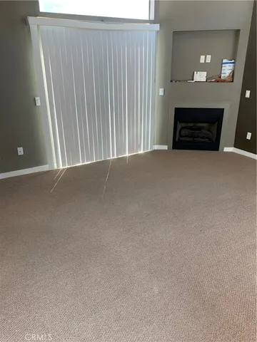 a view of an empty room and a window